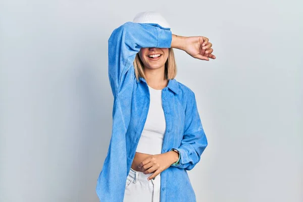 Beautiful Blonde Woman Wearing Wool Hat Covering Eyes Arm Smiling —  Fotos de Stock