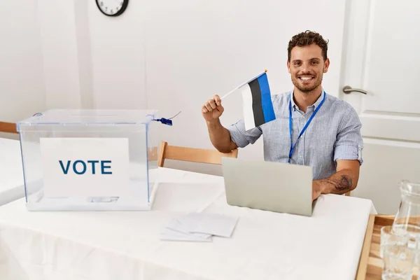 Young Hispanic Man Smiling Confident Holding Estonia Flag Working Electoral — Stock Photo, Image