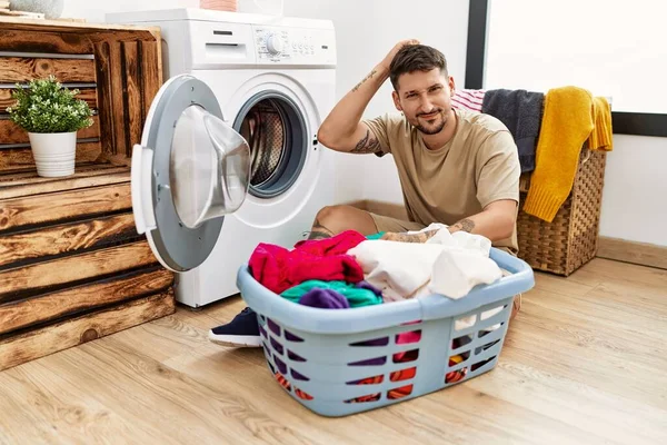 Young Handsome Man Putting Dirty Laundry Washing Machine Confuse Wonder — Foto Stock