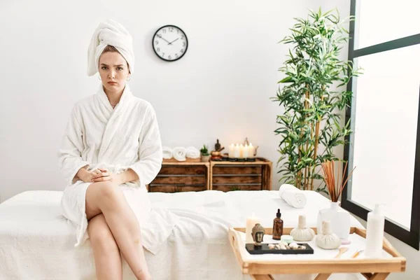 Young Blonde Woman Wearing Bathrobe Wellbeing Spa Skeptic Nervous Frowning — Foto de Stock