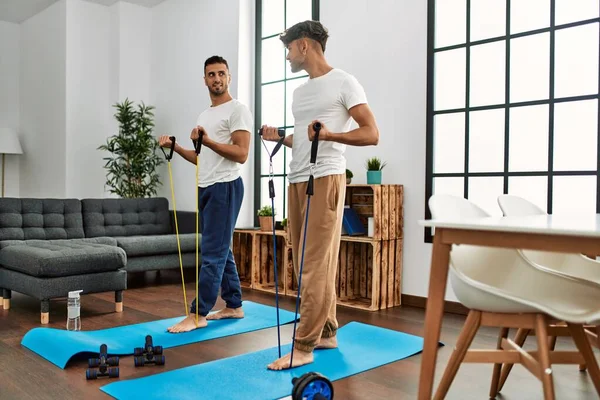 Dos Hombres Hispanos Pareja Sonriendo Confiado Entrenamiento Usando Banda Elástica — Foto de Stock