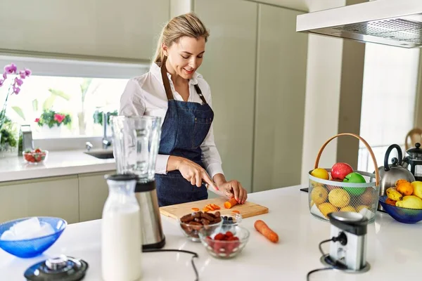 Young Blonde Woman Smiling Confident Cutting Carrot Kitchen — Stok fotoğraf