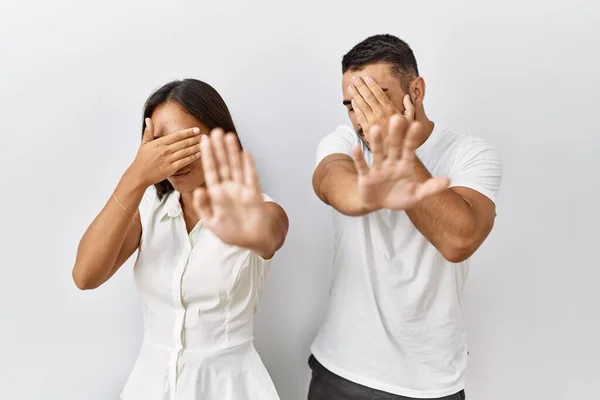 年轻的跨种族夫妇站在一起 用手捂住眼睛 用悲伤和恐惧的表情做着停止的手势 在孤立的背景下彼此相爱 尴尬和消极的概念 — 图库照片