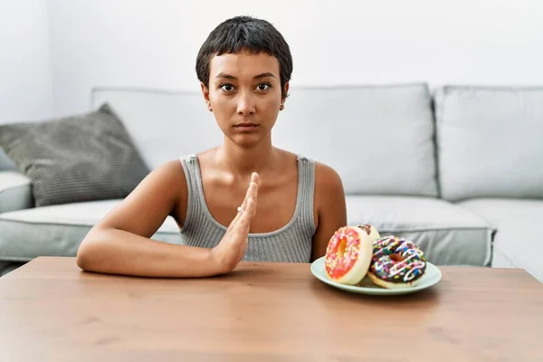 Young Hispanic Woman Rejecting Doughnut Home — Stock Photo, Image