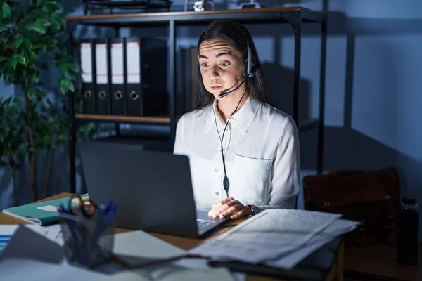 Young Brunette Woman Wearing Call Center Agent Headset Working Late — Stockfoto