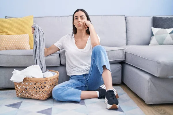 Young Brunette Woman Doing Laundry Home Looking Camera Blowing Kiss — Stock Fotó