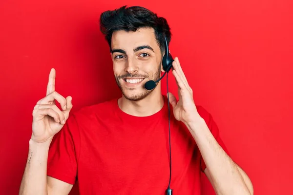 Young Hispanic Man Wearing Call Center Agent Headset Surprised Idea — Stock Photo, Image