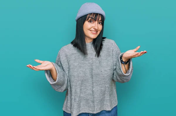 Young Hispanic Woman Wearing Cute Wool Cap Clueless Confused Expression — Stockfoto