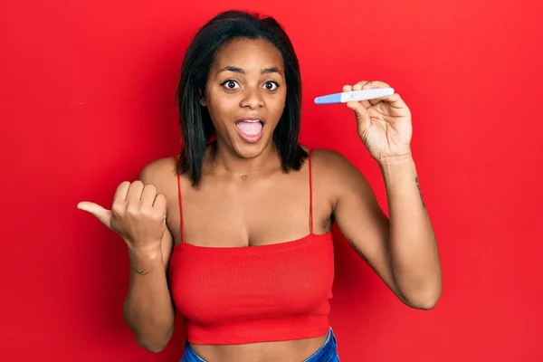 Young African American Girl Holding Pregnancy Test Result Pointing Thumb — Fotografia de Stock