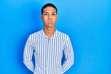 Sıradan kıyafetler giyen, komik yüzlü, yanak şişiren Afro-Amerikan bir genç. Havayla şişmiş ağız, çılgın bir ifade.. 