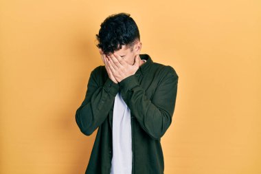 Ağlarken suratını ellerle kapatan, günlük kıyafetler giyen genç İspanyol. depresyon kavramı. 