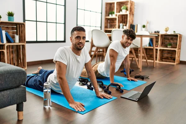 Two Hispanic Men Couple Smiling Confident Having Online Stretching Class — стоковое фото