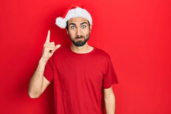 Young Hispanic Man Wearing Christmas Hat Pointing Finger Successful Idea — Foto de Stock