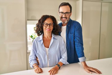 Orta yaşlı bir çift mutlu ve havalı bir gülümsemeyle birlikte ayakta duruyor. şanslı kişi. 