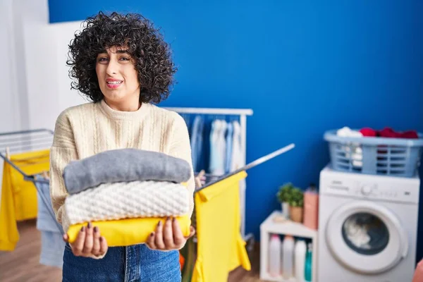 Young Brunette Woman Curly Hair Holding Clean Laundry Clueless Confused — Foto de Stock