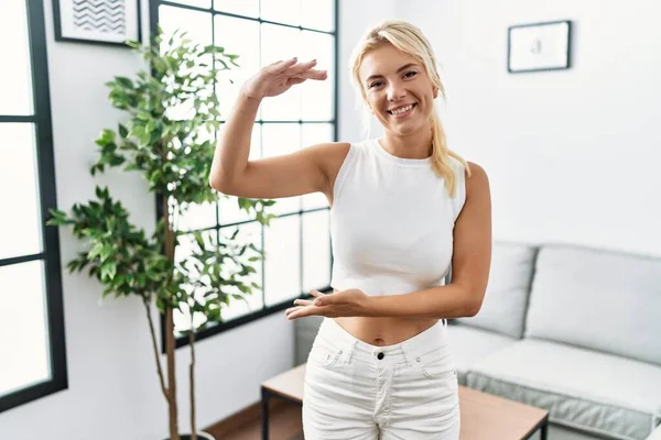 Young Caucasian Woman Standing Living Room Gesturing Hands Showing Big — Zdjęcie stockowe