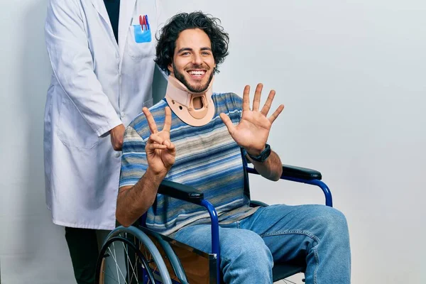 Handsome Hispanic Man Sitting Wheelchair Wearing Neck Collar Showing Pointing — Stock Photo, Image