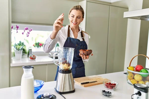 Young Blonde Woman Smiling Confident Pouring Dates Blender Kitchen — Stok fotoğraf