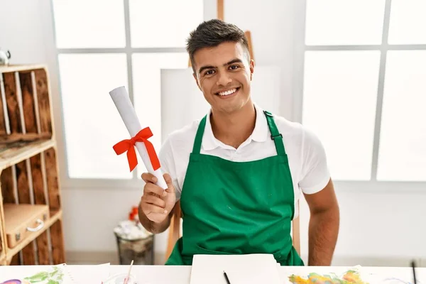 Young Hispanic Man Smiling Confident Holding Diploma Art Studio — Stock Fotó