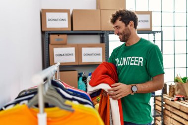 Yardım merkezinde çalışırken gülümseyen Latin asıllı gönüllü adam..