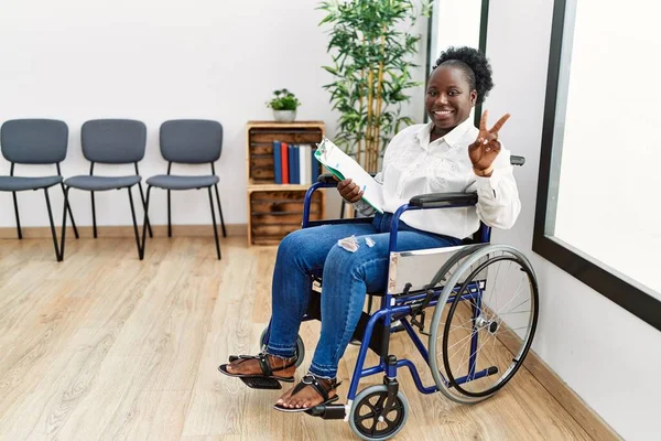 Young Black Woman Sitting Wheelchair Waiting Room Smiling Looking Camera — Stockfoto