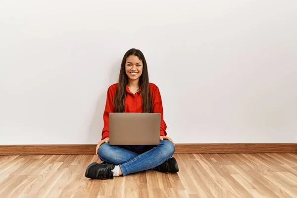 Young Brunette Woman Sitting Floor Empty Room Laptop Looking Positive —  Fotos de Stock