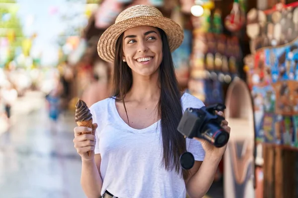 Young Hispanic Woman Tourist Eating Ice Cream Holding Reflex Camera — Stockfoto