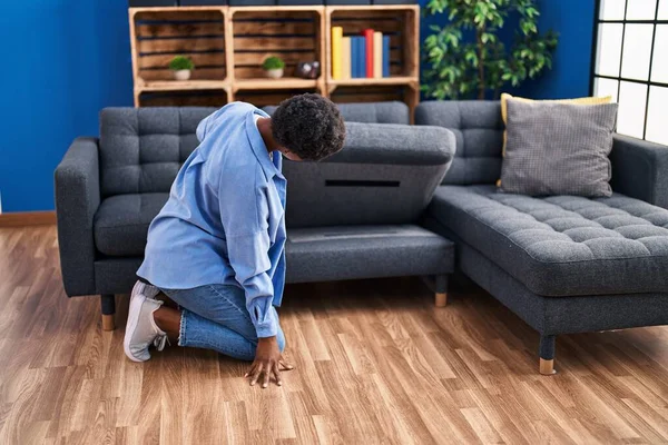 African American Woman Looking Sofa Home — стоковое фото
