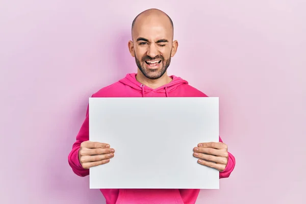 Young Bald Man Holding Blank Empty Banner Winking Looking Camera — ストック写真