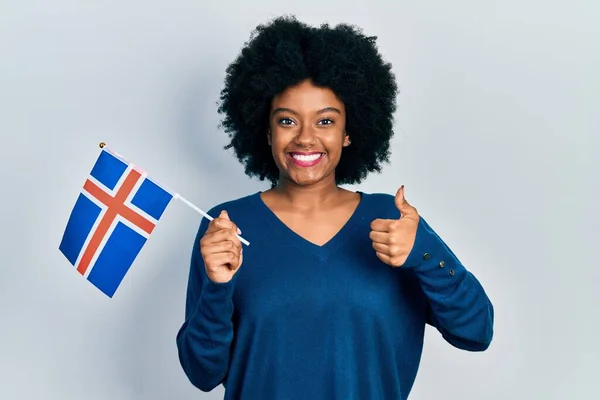 Young African American Woman Holding Iceland Flag Smiling Happy Positive — ストック写真