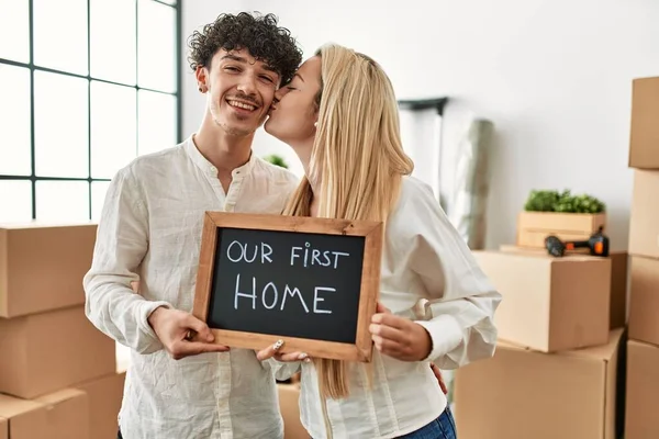 Young Beautiful Couple Holding Blackboard Our First Home Message — Stock Photo, Image