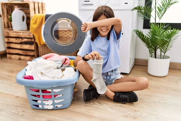 Young Hispanic Girl Doing Laundry Holding Socks Smiling Cheerful Playing — ストック写真