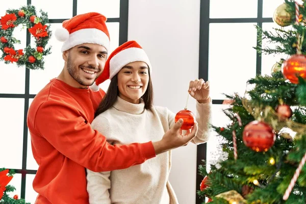 Genç Spanyol Çift Gülümsüyor Mutlu Noel Ağacı Süslüyor Evde — Stok fotoğraf