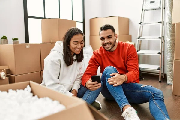 Young Latin Couple Smiling Happy Using Smartphone New Home — Stock Photo, Image