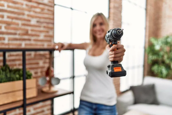 Young Blonde Woman Repairing Shelving Using Drill Home — Photo