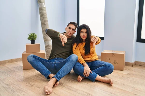 Young Couple Sitting Floor New Home Looking Unhappy Angry Showing — Stock Photo, Image