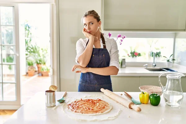 Beautiful Blonde Woman Wearing Apron Cooking Pizza Thinking Looking Tired — Stok fotoğraf