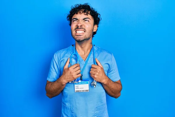 Young Hispanic Man Wearing Blue Male Nurse Uniform Angry Mad — ストック写真