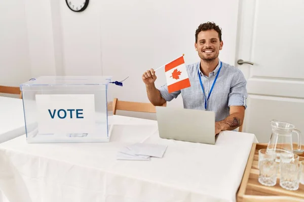 Young Hispanic Man Smiling Confident Holding Canada Flag Working Electoral — Stock Photo, Image