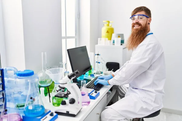 Young Redhead Man Wearing Scientist Uniform Working Laboratory — Stockfoto