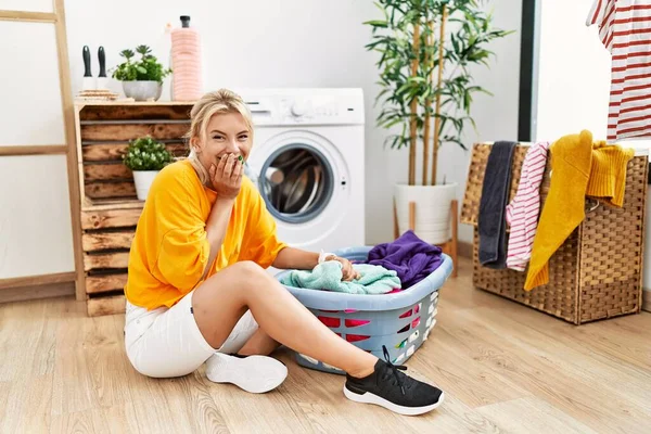 Young Caucasian Woman Putting Dirty Laundry Washing Machine Laughing Embarrassed — Fotografia de Stock
