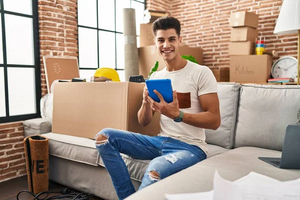 Young Hispanic Man Using Touchpad Sitting Sofa New Home — Stockfoto