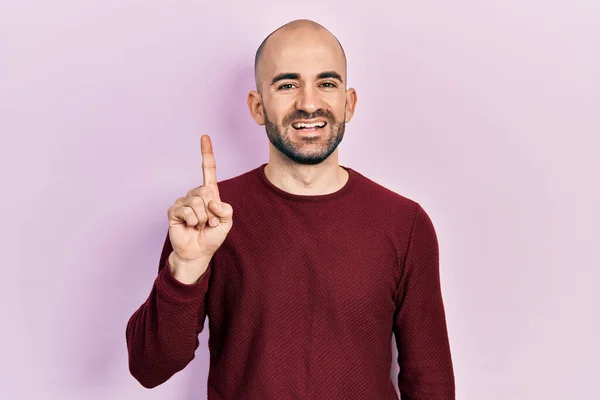 Young Bald Man Wearing Casual Clothes Showing Pointing Finger Number — Stock fotografie
