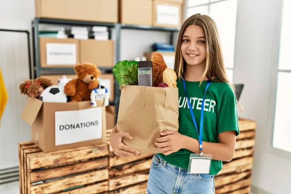 Adorable Girl Wearing Volunteer Uniform Holding Groceries Paper Bag Charity — Fotografia de Stock