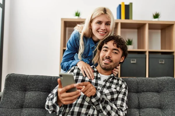 Jeune Couple Utilisant Smartphone Assis Sur Canapé Maison — Photo