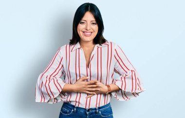 Gündelik kıyafetler giyen genç İspanyol kız gülümseyerek kahkahalarla gülüyor çünkü elleri vücutta olan komik, çılgın bir şaka.. 