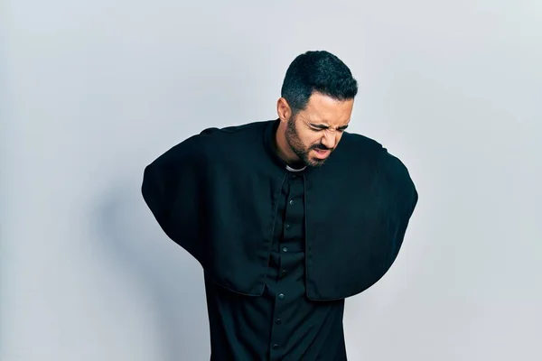 Handsome Hispanic Man Beard Wearing Catholic Priest Robe Suffering Backache — Stock Fotó