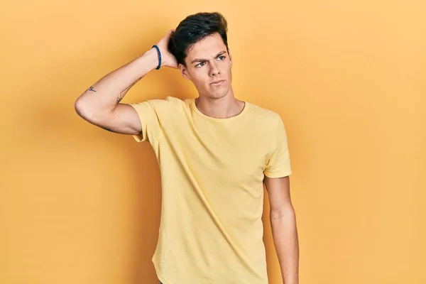 Young Hispanic Man Wearing Casual Yellow Shirt Confuse Wondering Question — Fotografia de Stock