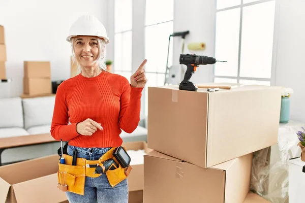 Middle Age Grey Haired Woman Wearing Hardhat Standing New Home — Stockfoto