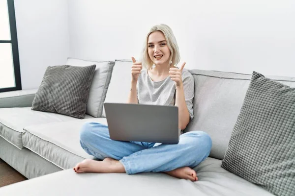 Young Caucasian Woman Using Laptop Home Sitting Sofa Success Sign — Stok fotoğraf